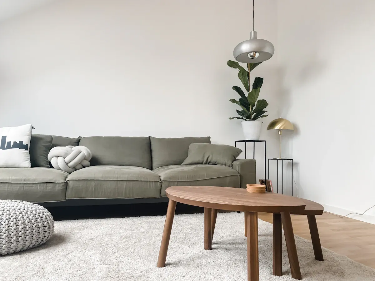A gray sofa and wooden coffee table in a living room